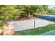 Community sand volleyball court next to a tennis court, offering recreational opportunities for residents at 5059 Winding Hills Lane Ln, Woodstock, GA 30189