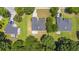 Aerial view of several homes in a residential neighborhood with mature trees and well-maintained yards at 706 Hillmont Dr, Loganville, GA 30052