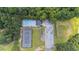 Aerial view of a community pool with lounge chairs, tennis court, parking, playground, and lush greenery at 706 Hillmont Dr, Loganville, GA 30052