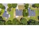An overhead shot of multiple residential homes in a neighborhood setting with established trees and driveways at 706 Hillmont Dr, Loganville, GA 30052