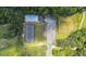 Overhead community view of the pool with lounge chairs, tennis court, playground, and parking area surrounded by trees at 706 Hillmont Dr, Loganville, GA 30052