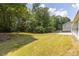Beautiful backyard view with a sprawling lawn and mature trees that create a peaceful and private outdoor retreat at 706 Hillmont Dr, Loganville, GA 30052