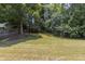 Beautiful backyard featuring mature trees and lush greenery offering a serene and private outdoor experience at 706 Hillmont Dr, Loganville, GA 30052