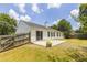 Exterior of home with a spacious backyard, concrete patio, and wooden fence at 706 Hillmont Dr, Loganville, GA 30052