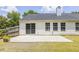 White home exterior featuring a concrete patio, sliding glass doors, and a fenced yard at 706 Hillmont Dr, Loganville, GA 30052