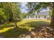 Expansive backyard featuring a well-maintained lawn, mature trees, and a charming patio area ideal for outdoor relaxation at 706 Hillmont Dr, Loganville, GA 30052