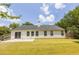 The backyard has a spacious lawn area, surrounded by a privacy fence, and mature trees at 706 Hillmont Dr, Loganville, GA 30052
