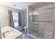 Stylish bathroom featuring white subway tile shower, dual sinks, and gray accents at 706 Hillmont Dr, Loganville, GA 30052