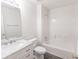 Bathroom featuring modern vanity with marble countertop and shower-tub combination at 706 Hillmont Dr, Loganville, GA 30052