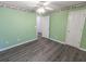 Green bedroom featuring hard floors, a window and two doors leading to other rooms at 706 Hillmont Dr, Loganville, GA 30052