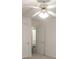 Bedroom featuring a ceiling fan and open closet doors to the ensuite at 706 Hillmont Dr, Loganville, GA 30052