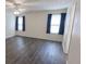 Bright bedroom with large windows, ceiling fan, and hardwood flooring at 706 Hillmont Dr, Loganville, GA 30052