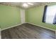 Green bedroom featuring hard floors, a window and a closet with a white door at 706 Hillmont Dr, Loganville, GA 30052