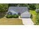 Charming home features a well-manicured front yard, inviting entrance, and a convenient attached two-car garage at 706 Hillmont Dr, Loganville, GA 30052