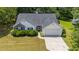 Charming home features a well-manicured front yard, inviting entrance, and a convenient attached two-car garage at 706 Hillmont Dr, Loganville, GA 30052
