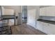 Spacious kitchen features white cabinets, stainless steel appliances, and wood-look floors at 706 Hillmont Dr, Loganville, GA 30052