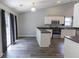 Kitchen and dining area with sliding glass doors and white cabinets at 706 Hillmont Dr, Loganville, GA 30052