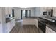 Modern kitchen with white cabinets and stainless steel appliances at 706 Hillmont Dr, Loganville, GA 30052