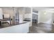 Open kitchen featuring white cabinets, stainless steel appliances, and hardwood floors at 706 Hillmont Dr, Loganville, GA 30052