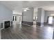 Open living area with gray walls with molding, fireplace, wood-look flooring, kitchen, and dining area at 706 Hillmont Dr, Loganville, GA 30052
