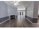 Bright and open living room featuring a fireplace, gray walls, and luxury vinyl flooring at 706 Hillmont Dr, Loganville, GA 30052