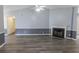 Spacious living room featuring a fireplace, high ceilings, gray walls with molding, and stylish wood-look floors at 706 Hillmont Dr, Loganville, GA 30052