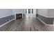 Elegant living room showcasing a fireplace, gray walls with decorative molding, and modern wood-look flooring at 706 Hillmont Dr, Loganville, GA 30052