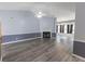 Bright living room boasting vaulted ceilings, fireplace, gray walls with molding, and modern wood-look floors at 706 Hillmont Dr, Loganville, GA 30052