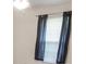 Window with blinds and dark curtains letting light into a bedroom space at 706 Hillmont Dr, Loganville, GA 30052