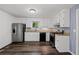 Features an updated kitchen with white cabinets, stainless steel appliances and luxury vinyl flooring at 880 Winfield Sw Ct, Marietta, GA 30060