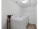 Clean laundry room with white appliances and a wire shelf at 880 Winfield Sw Ct, Marietta, GA 30060