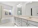 Bright bathroom featuring dual sinks, a soaking tub, and ample counter space at 1536 Baxley Pine Trce, Suwanee, GA 30024