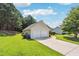 Detached two-car garage with a long driveway and a lush green lawn at 2410 Napa Valley Dr, Villa Rica, GA 30180