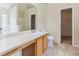 Bathroom featuring a vanity with solid-surface countertop, sink, toilet and open door to the closet at 2410 Napa Valley Dr, Villa Rica, GA 30180