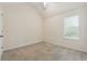 Bedroom with vaulted ceiling, neutral walls, carpet flooring, and a large window at 2410 Napa Valley Dr, Villa Rica, GA 30180