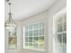 Bright dining room with large windows offering lots of natural light and stylish chandelier at 2410 Napa Valley Dr, Villa Rica, GA 30180
