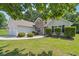 Charming one-story home with well-maintained landscaping, a two-car garage, and stone accents at 2410 Napa Valley Dr, Villa Rica, GA 30180