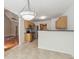 Open kitchen with tile flooring, stainless steel appliances and modern lighting at 2410 Napa Valley Dr, Villa Rica, GA 30180