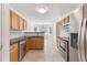 Bright kitchen with stainless steel appliances, wood cabinets, and tile floors at 2410 Napa Valley Dr, Villa Rica, GA 30180