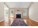 Cozy living room features a fireplace, hardwood floors, and a door leading to the backyard at 2410 Napa Valley Dr, Villa Rica, GA 30180