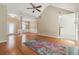 Bright living room with vaulted ceilings, hardwood floors, ceiling fan, and a colorful area rug at 2410 Napa Valley Dr, Villa Rica, GA 30180