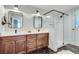 Bathroom featuring a glass-enclosed shower, dual vanity with dark wood cabinets, and hexagon tile flooring at 2936 Randolph Ne Rd, Atlanta, GA 30345