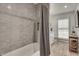 Bathroom featuring tub/shower combo with gray subway tile surround and basketweave tile floor at 2936 Randolph Ne Rd, Atlanta, GA 30345