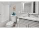 Cozy bathroom with a marble countertop, white cabinets, and a tub with subway tile at 2936 Randolph Ne Rd, Atlanta, GA 30345