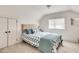 Bedroom featuring a neatly made bed, a large window, and a closet with double doors at 2936 Randolph Ne Rd, Atlanta, GA 30345