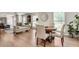 Bright dining area with hardwood floors and stylish seating adjacent to living area at 2936 Randolph Ne Rd, Atlanta, GA 30345