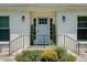 Close up of the home's entry showing a blue front door flanked by black sconces at 2936 Randolph Ne Rd, Atlanta, GA 30345