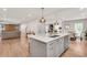 Open-concept kitchen island view with living and dining areas, and modern finishes at 2936 Randolph Ne Rd, Atlanta, GA 30345