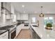 Gourmet kitchen featuring stone countertops, stainless steel appliances, and a center island at 2936 Randolph Ne Rd, Atlanta, GA 30345