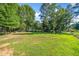 Wide shot of the home's expansive and well-maintained backyard with lush green grass at 3540 Pilgrim Mill Rd, Cumming, GA 30041